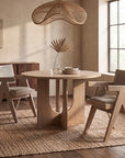 Modern Guisborough Arm Chair featuring a light gray upholstered foam-filled seat cushion and backrest, supported by a distinctive natural oak wood frame with a trestle base and inverted V-leg design, isolated on a white background.